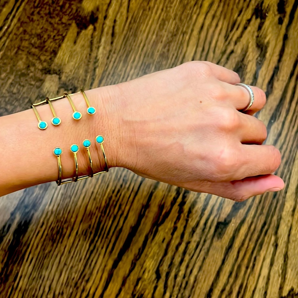 Adjustable gold bracelet with turquoise stones.